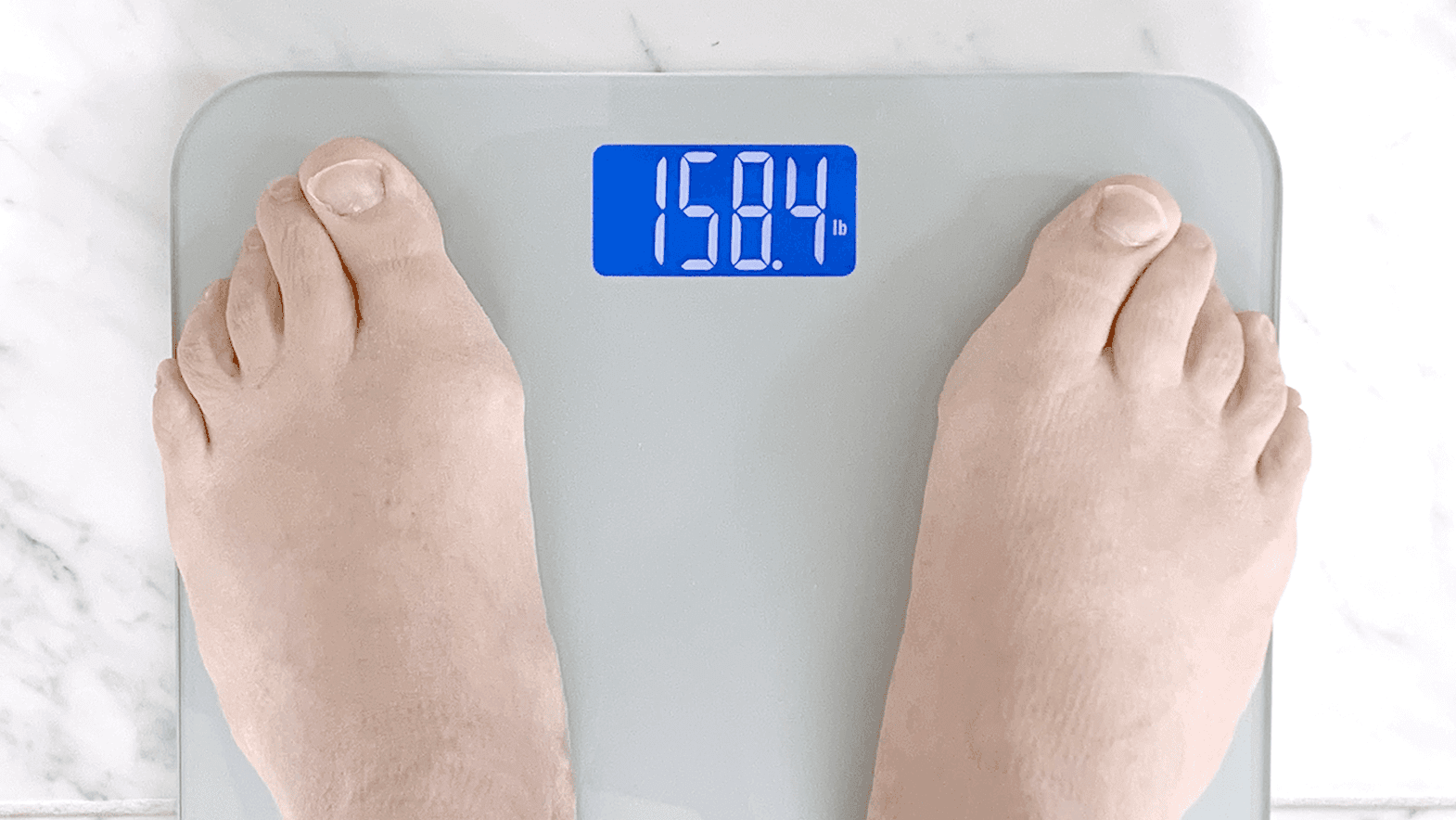 feet on a scale showing current weight