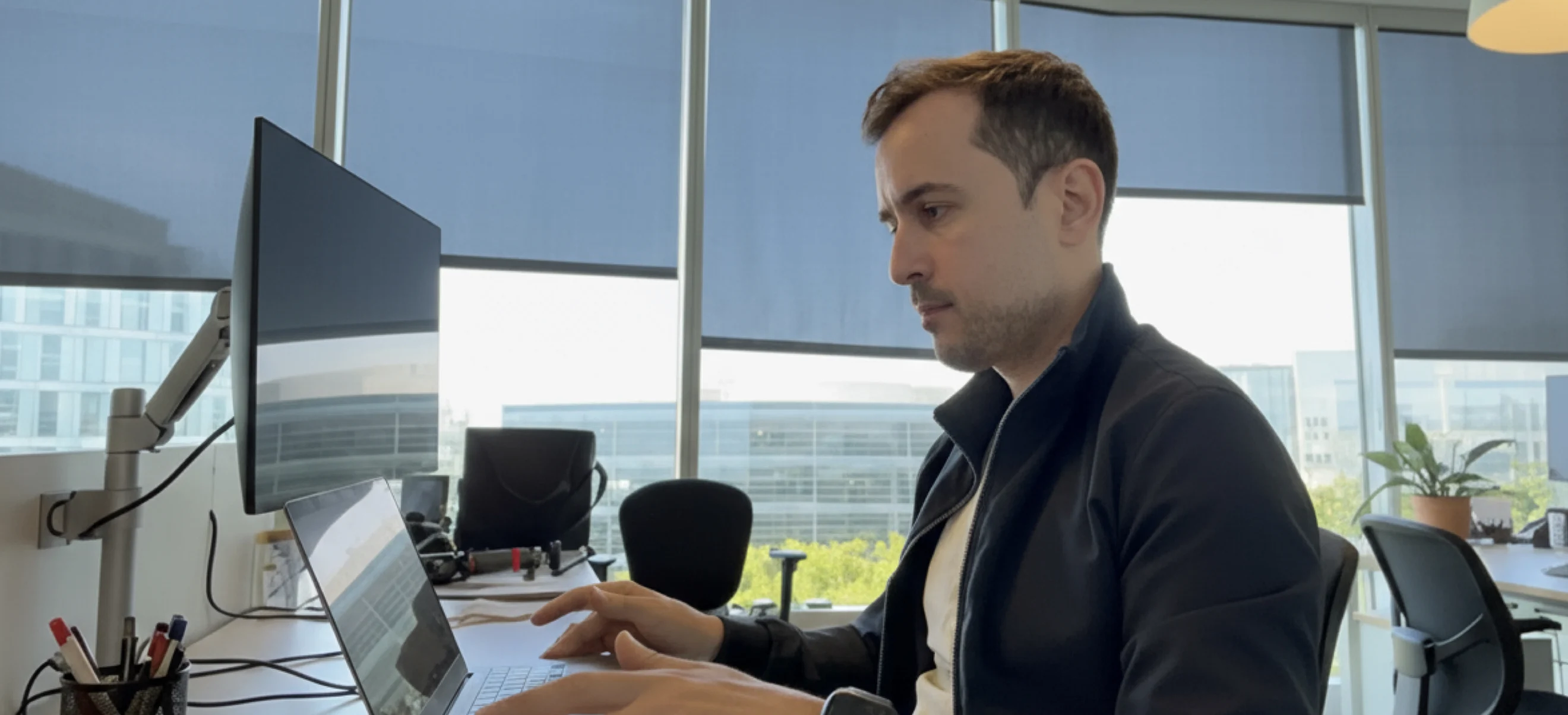 Luciano Ayres sitting at an office workstation