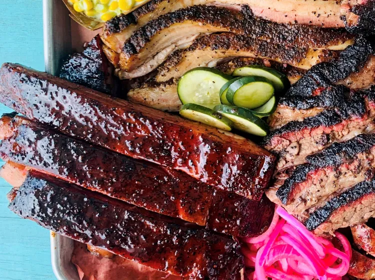 A close-up view of a platter of various smoked meats
