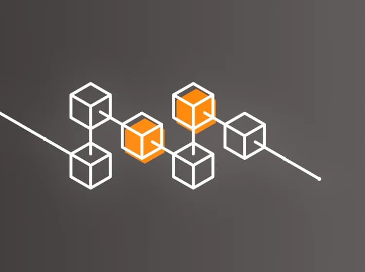 Abstract graphic of white-lined cubes, some filled with orange, arranged against a dark gray background, evoking the concept of blockchain in a visually striking manner.
