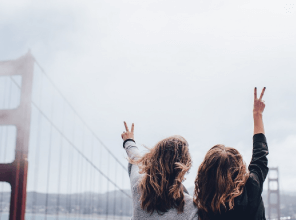 Women taking a selfie in front of a bridge
