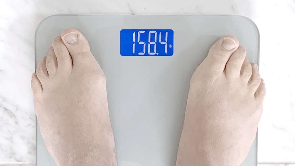 feet on a scale showing current weight