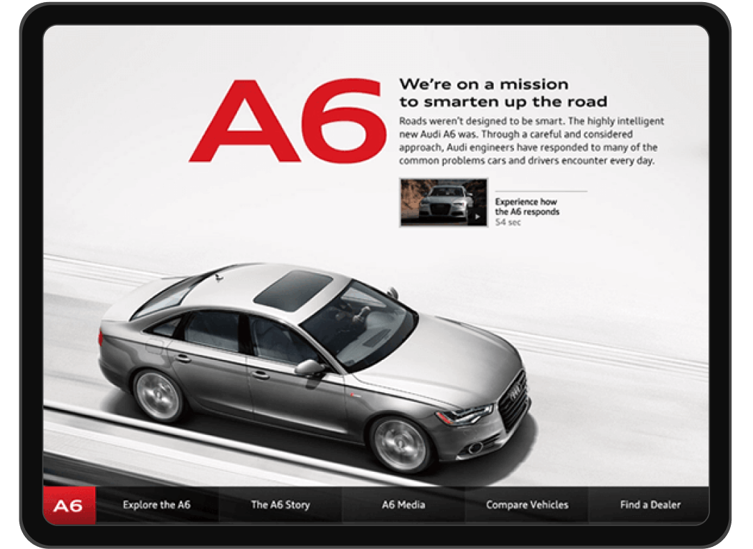 Audi A6 Test Drive experience. A car races down a highway, with text: We are on a mission to smarten up the road. Buttons to view more details about the Audi A6, compare vehicles, and find a dealer.